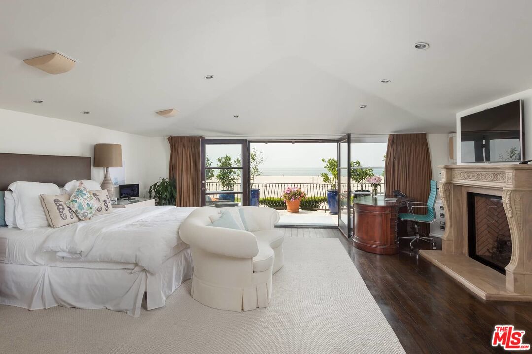 703 Palisades Beach Road Santa Monica, CA 90402 - Photo 25 of 37 a living room with furniture large window and a fireplace