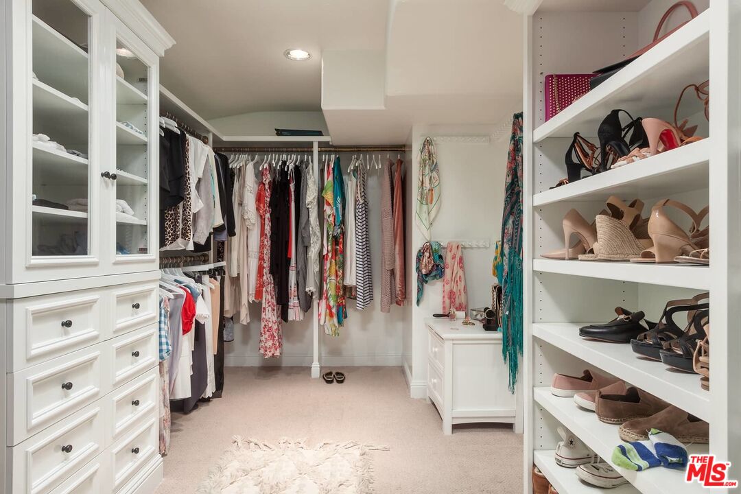 703 Palisades Beach Road Santa Monica, CA 90402 - Photo 31 of 37 a view of walk in closet with clothes and shoes