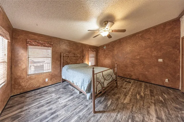 a spacious bedroom with a bed and a window