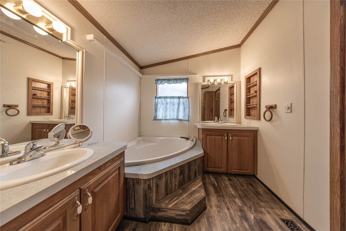 715 Bee Gee Road Driftwood, TX 78619 - Photo 13 of 40 a bathroom with a sink and a mirror