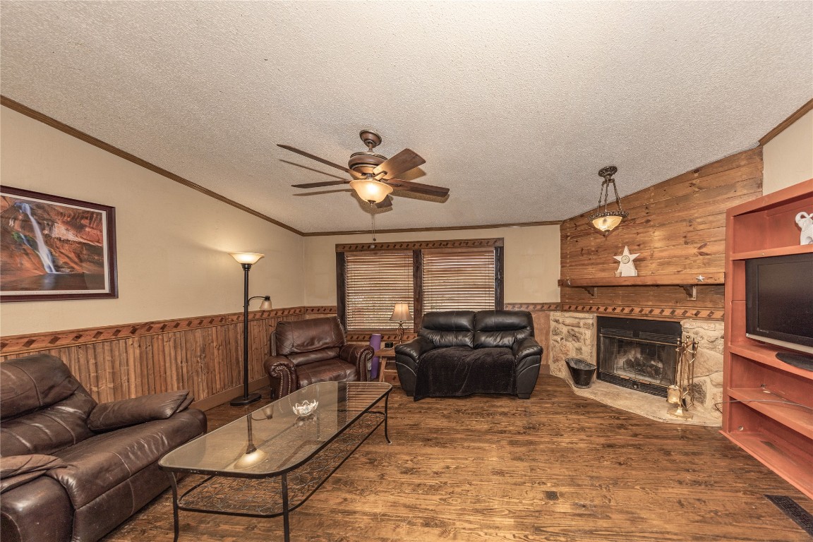 715 Bee Gee Road Driftwood, TX 78619 - Photo 19 of 40 a living room with furniture a fireplace and a flat screen tv