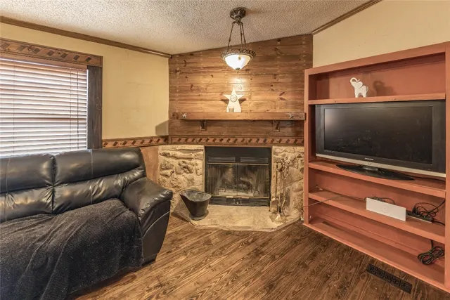 a living room with furniture a flat screen tv and a fireplace