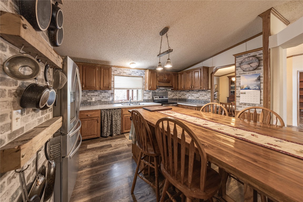 715 Bee Gee Road Driftwood, TX 78619 - Photo 22 of 40 a kitchen with granite countertop a sink a counter space appliances and cabinets
