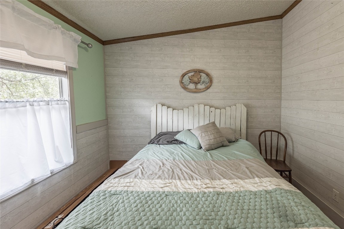 715 Bee Gee Road Driftwood, TX 78619 - Photo 28 of 40 a bedroom with a bed and a window