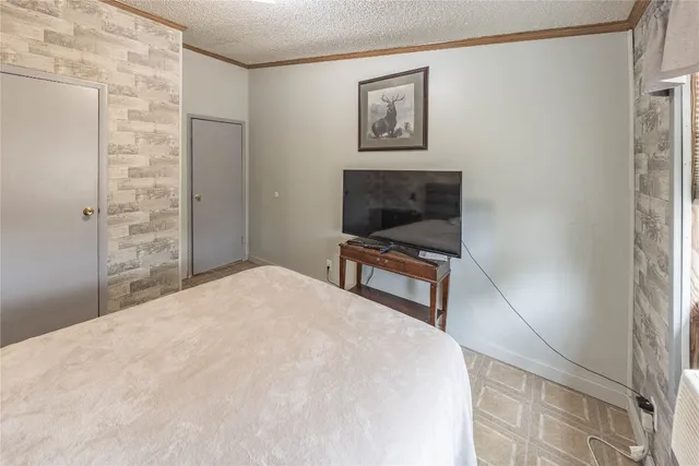 a bedroom with a bed and a wall painting