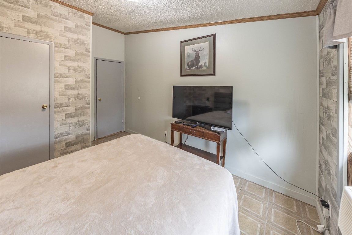 715 Bee Gee Road Driftwood, TX 78619 - Photo 32 of 40 a bedroom with a bed and a wall painting