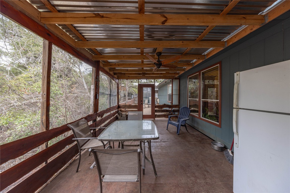 715 Bee Gee Road Driftwood, TX 78619 - Photo 40 of 40 a dining room with furniture and a floor to ceiling window