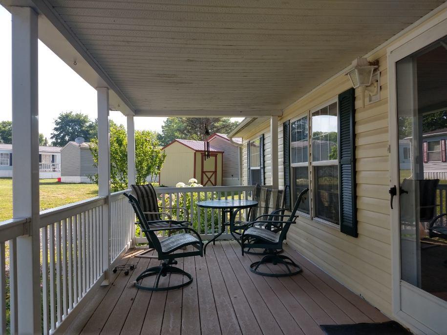 14 Ruby Drive Grove City, PA 16127 - Photo 3 of 17 a view of a chairs and table in patio with wooden floor