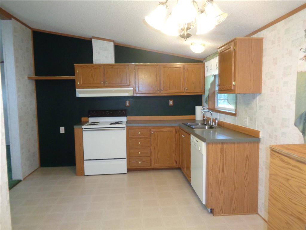 14 Ruby Drive Grove City, PA 16127 - Photo 5 of 17 a kitchen with a stove sink and cabinets