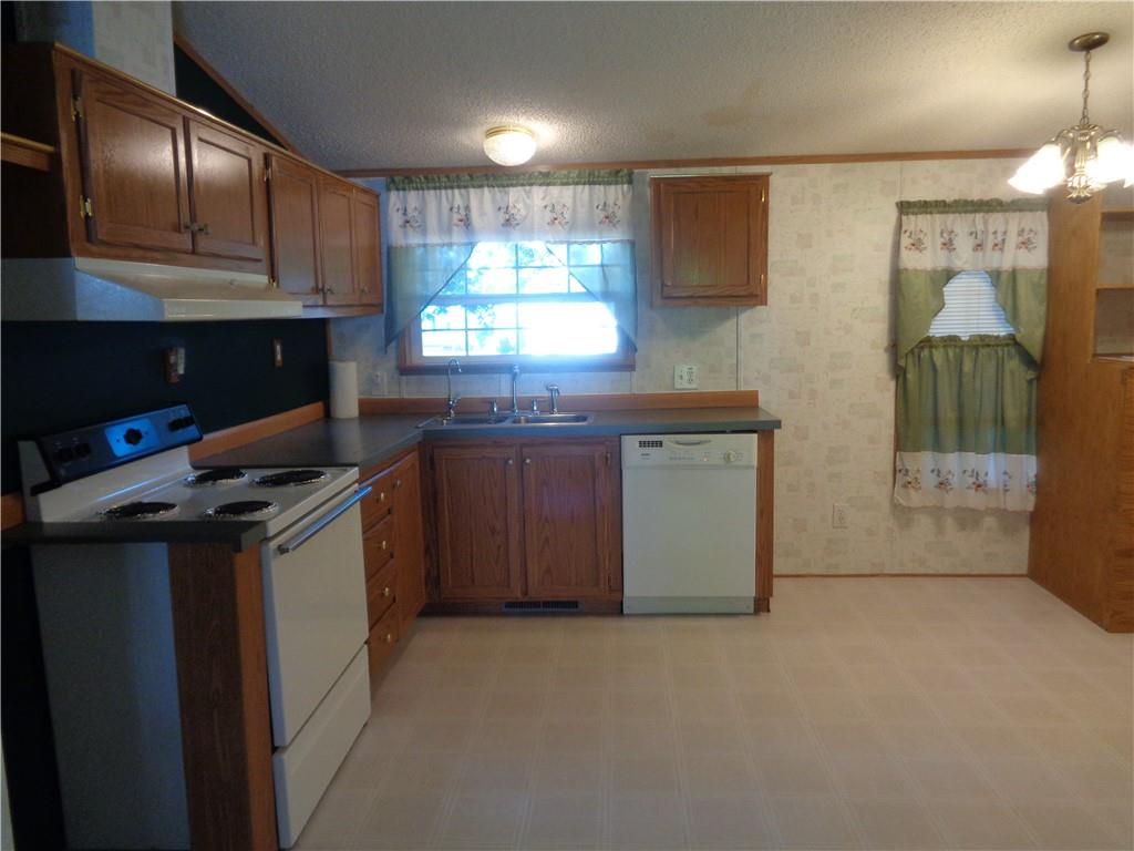 14 Ruby Drive Grove City, PA 16127 - Photo 7 of 17 a kitchen with stainless steel appliances granite countertop a stove a sink and a microwave