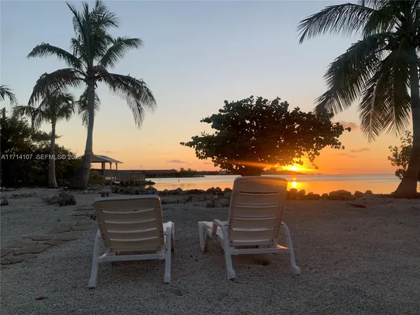 a view of a chairs and table in the patio