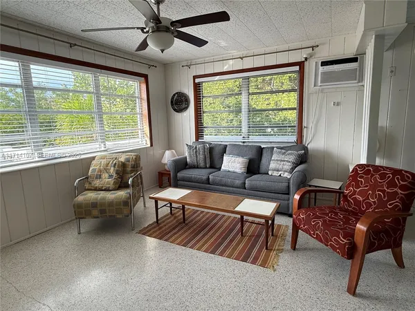 a view of a livingroom with furniture and a window