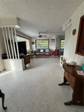 a spacious bedroom with a bed and a chandelier