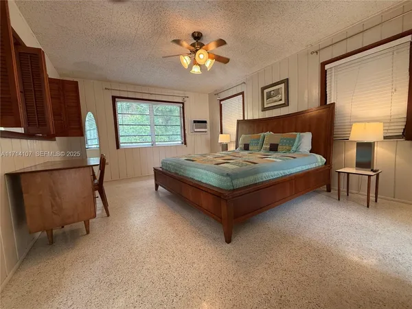 a living room with a table chairs and a dining table