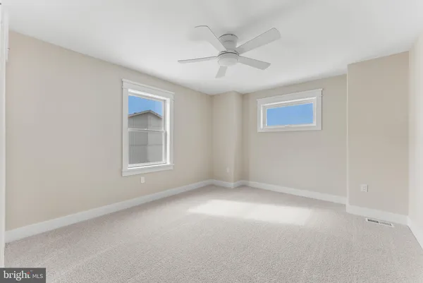 a view of a livingroom with furniture chandelier and front door