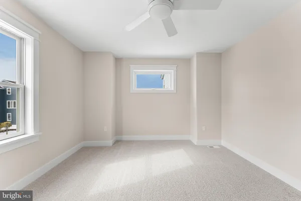 a view of an empty room with a fireplace and a window
