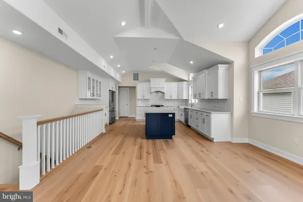 a view of empty room with wooden floor and fireplace