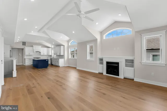 a large kitchen with stainless steel appliances kitchen island granite countertop a large counter top and a stove top oven