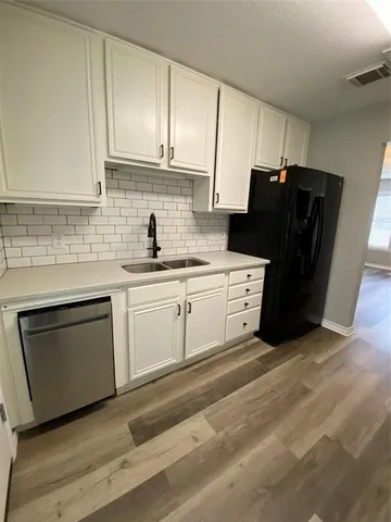 a kitchen with a sink a stove and refrigerator