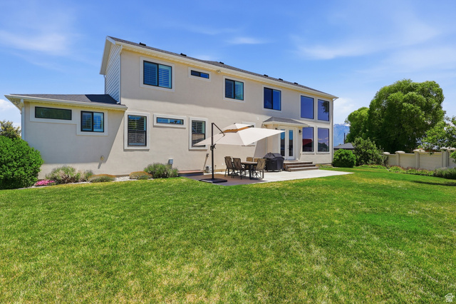 10676 Urban Rdg Cove South Jordan, UT 84095 - Photo 43 of 48 Expansive green lawn with a patio area