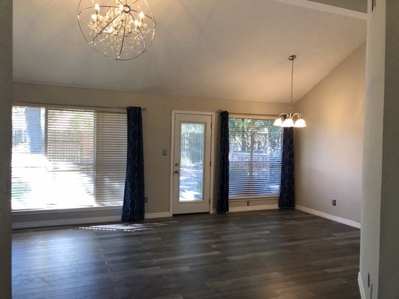 19707 Auburn Park Lane Spring, TX 77379 - Photo 3 of 16 an empty room with wooden floor and windows