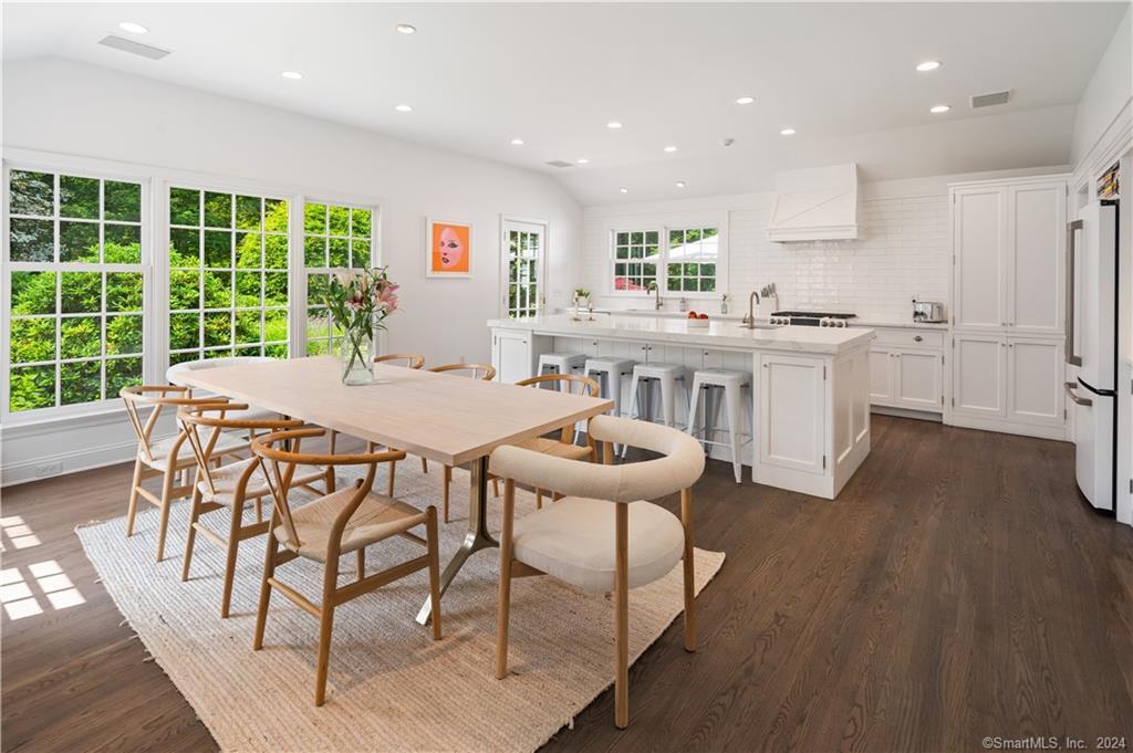 782 Smith Ridge Road New Canaan, CT 06840 - Photo 11 of 28 a kitchen with stainless steel appliances kitchen island granite countertop a table chairs sink and cabinets