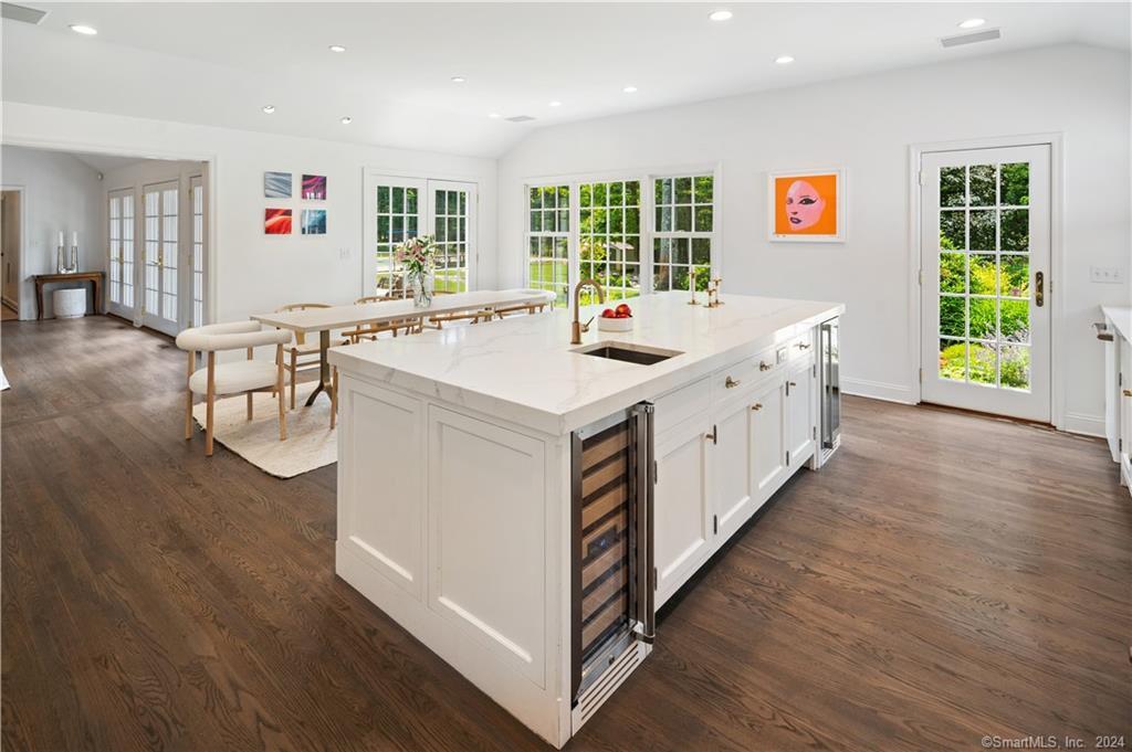 782 Smith Ridge Road New Canaan, CT 06840 - Photo 13 of 28 a large white kitchen with stainless steel appliances granite countertop a stove and a wooden floors