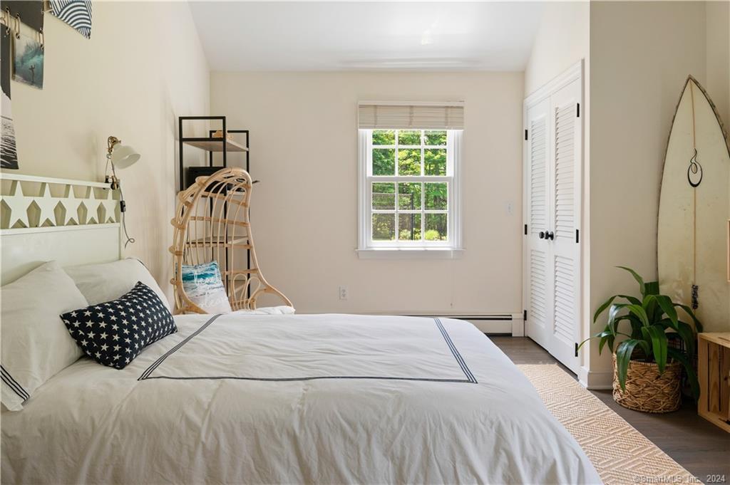 782 Smith Ridge Road New Canaan, CT 06840 - Photo 21 of 28 a bedroom with a bed table and a window