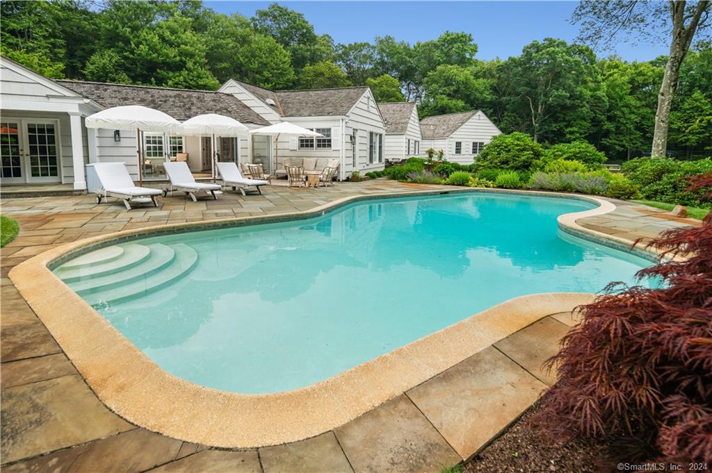 782 Smith Ridge Road New Canaan, CT 06840 - Photo 5 of 28 a view of a house with pool plants and large trees