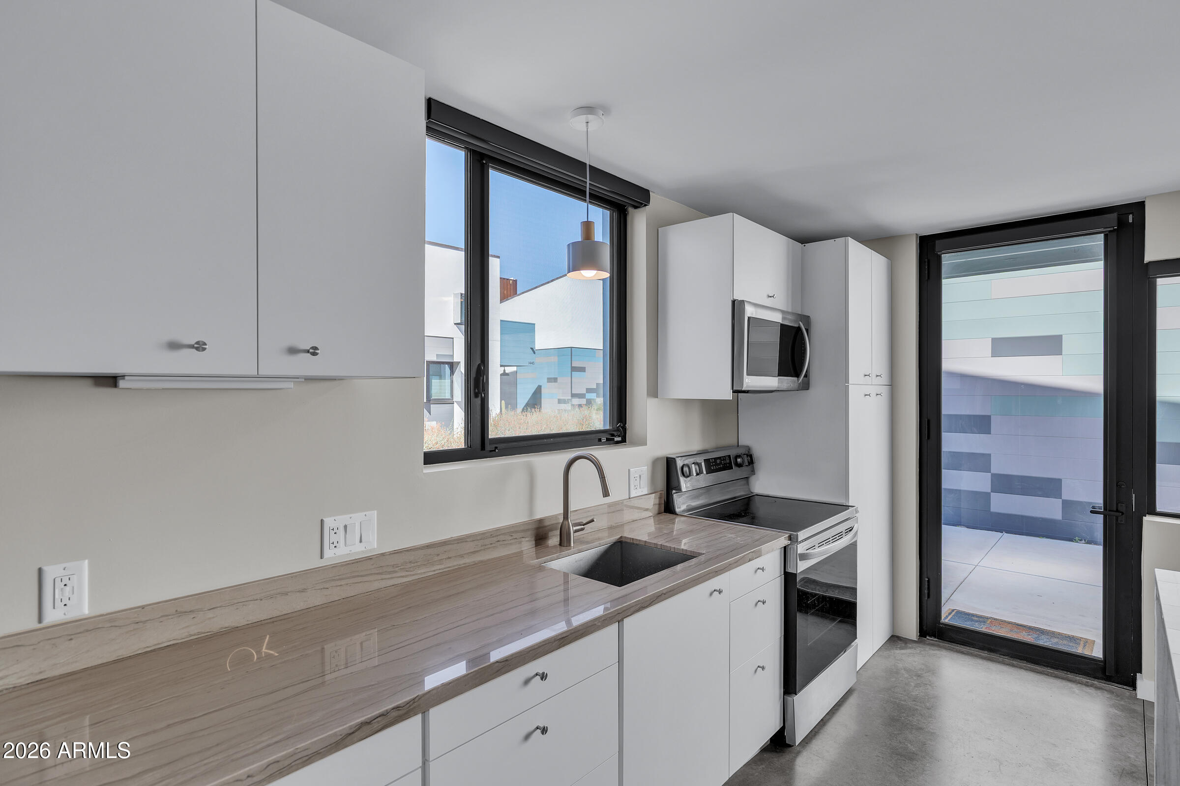 1491 South Rita Lane Tempe, AZ 85281 - Photo 11 of 15 a kitchen with a sink and cabinets