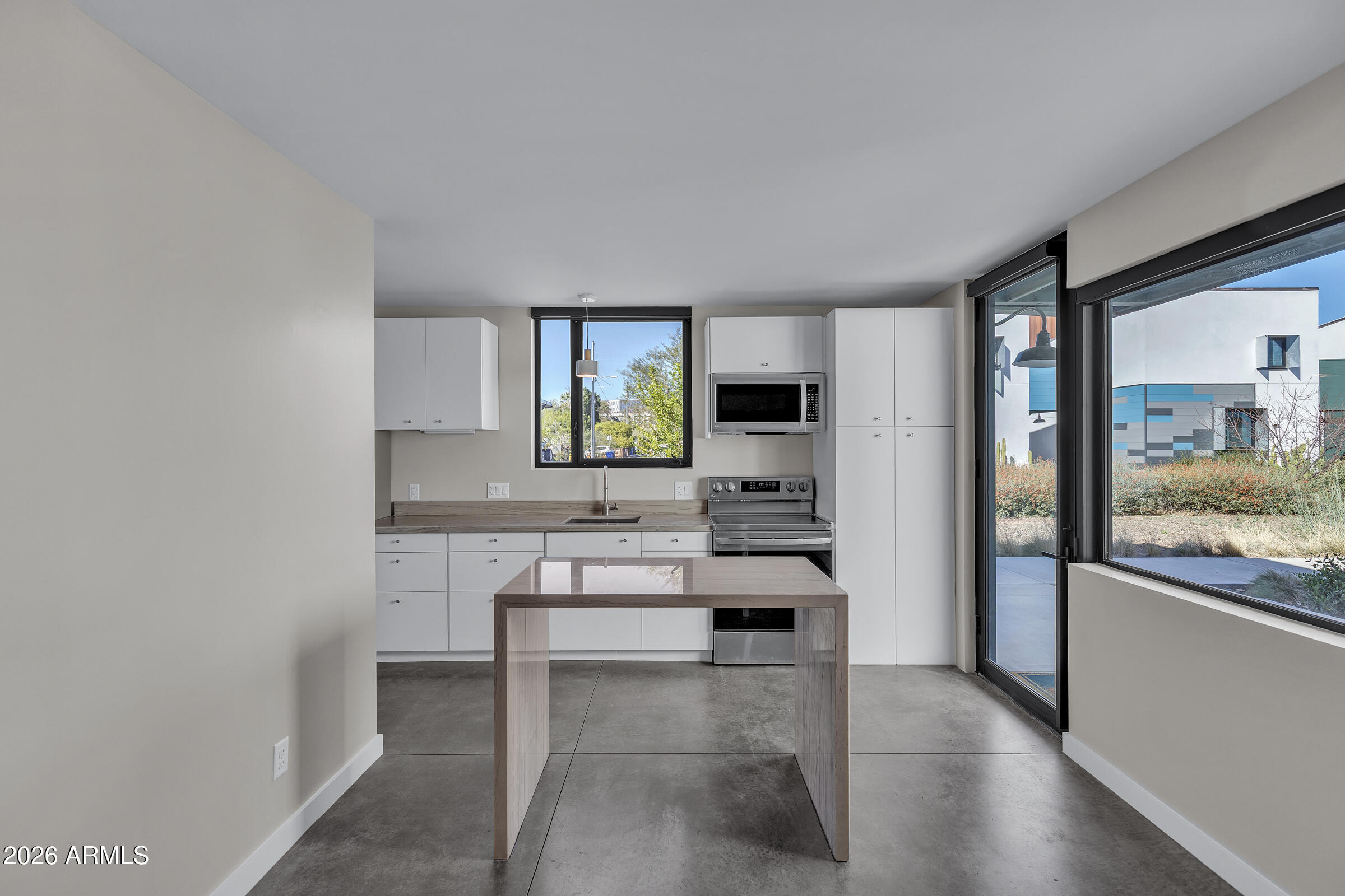 1491 South Rita Lane Tempe, AZ 85281 - Photo 9 of 15 a living room with stainless steel appliances kitchen island granite countertop a stove and a sink