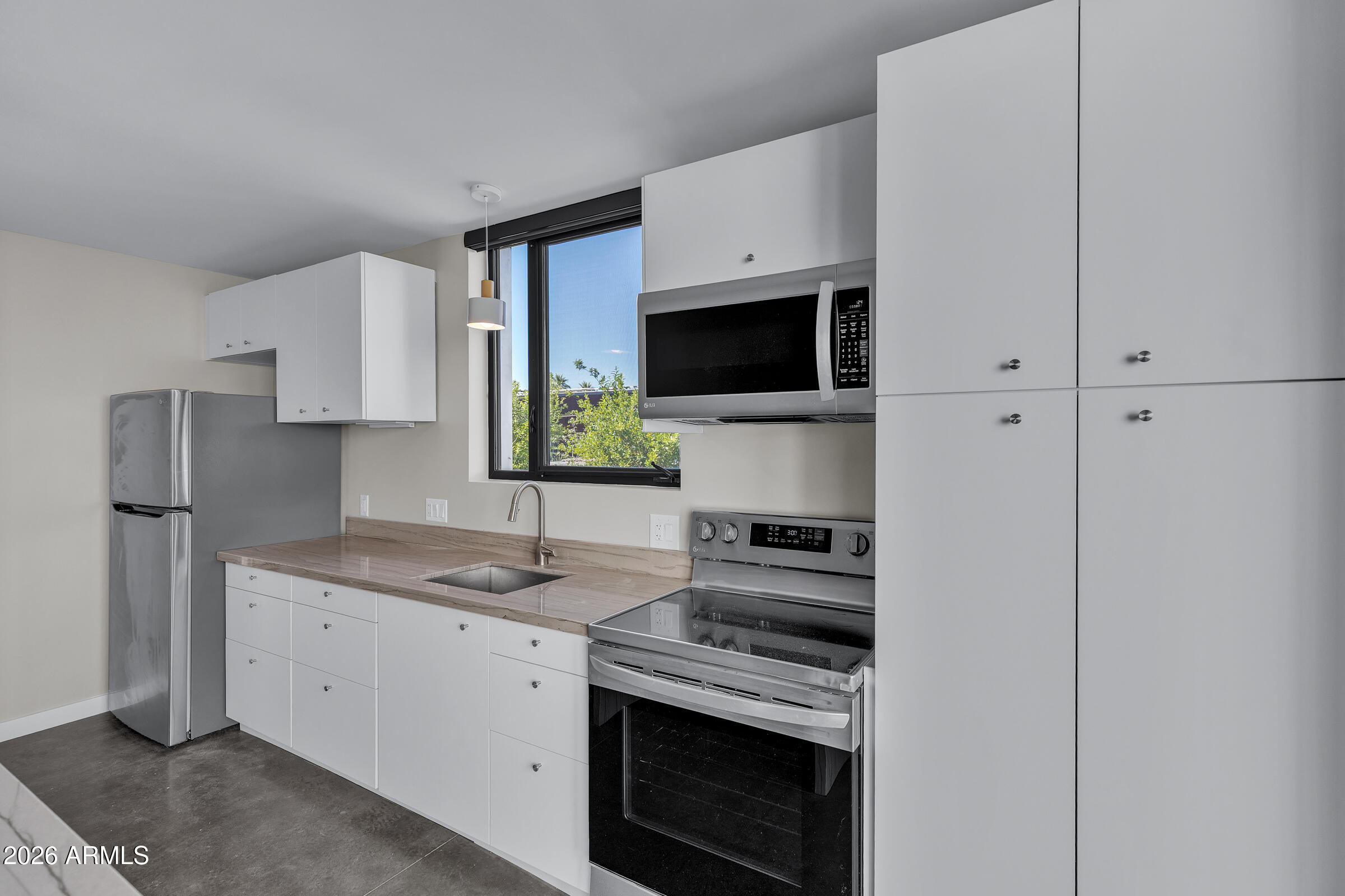 1491 South Rita Lane Tempe, AZ 85281 - Photo 10 of 15 a kitchen with stainless steel appliances a stove microwave and sink