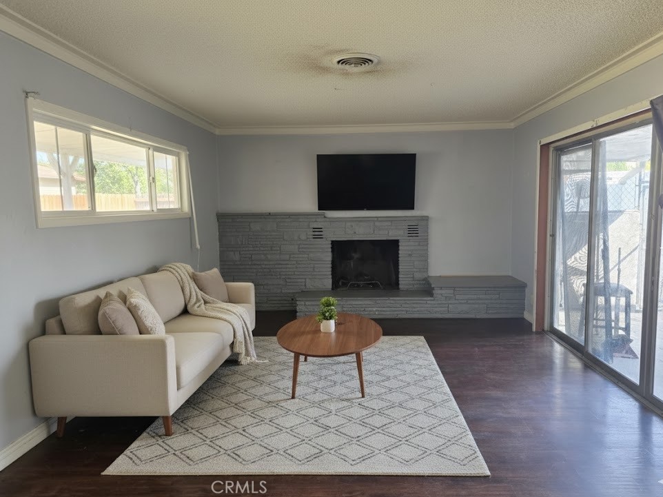 7072 Kermore Lane Stanton, CA 90680 - Photo 5 of 24 a living room with furniture a flat screen tv and a fireplace