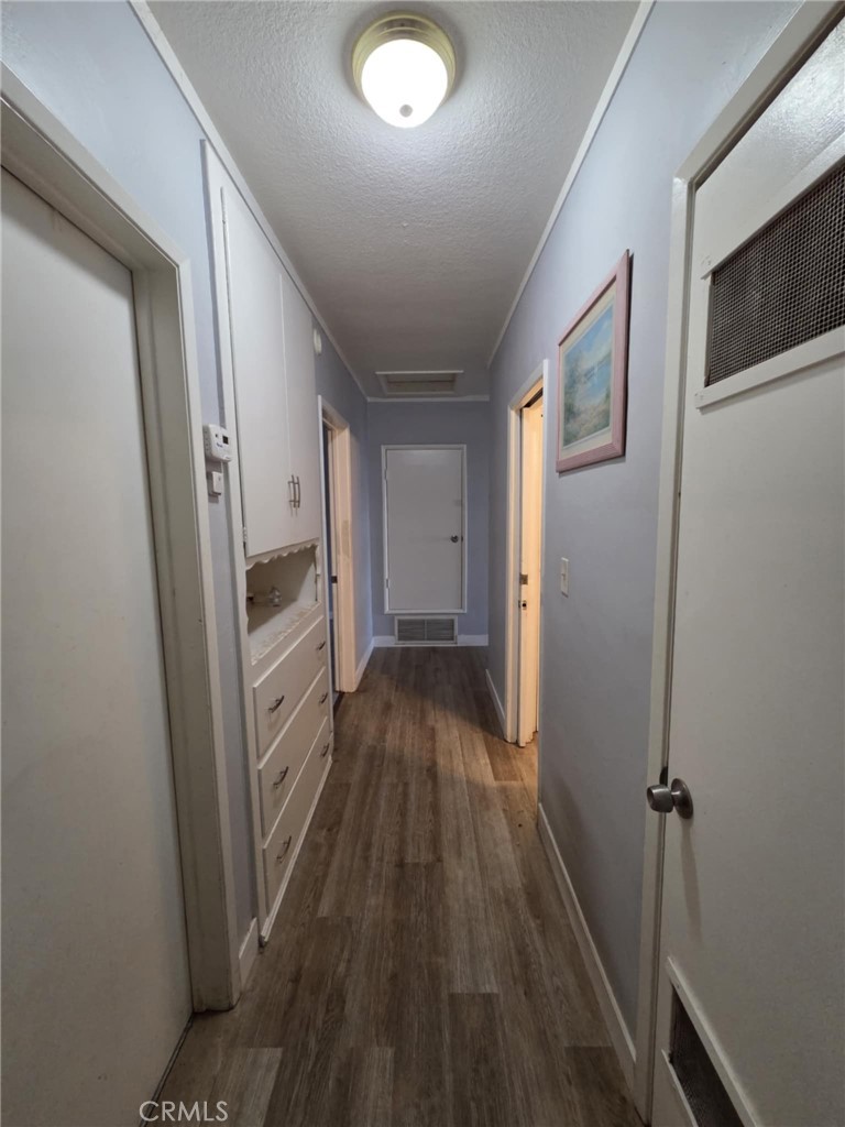 7072 Kermore Lane Stanton, CA 90680 - Photo 7 of 24 a view of a hallway with wooden floor and staircase