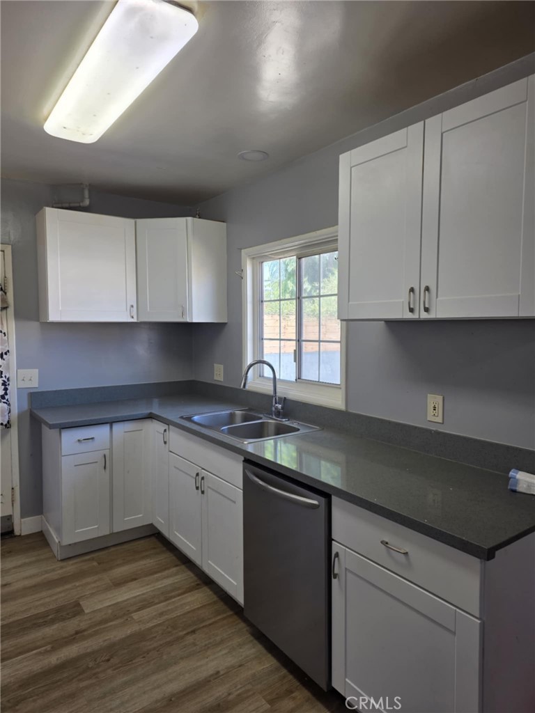 7072 Kermore Lane Stanton, CA 90680 - Photo 8 of 24 a kitchen with granite countertop white cabinets and sink