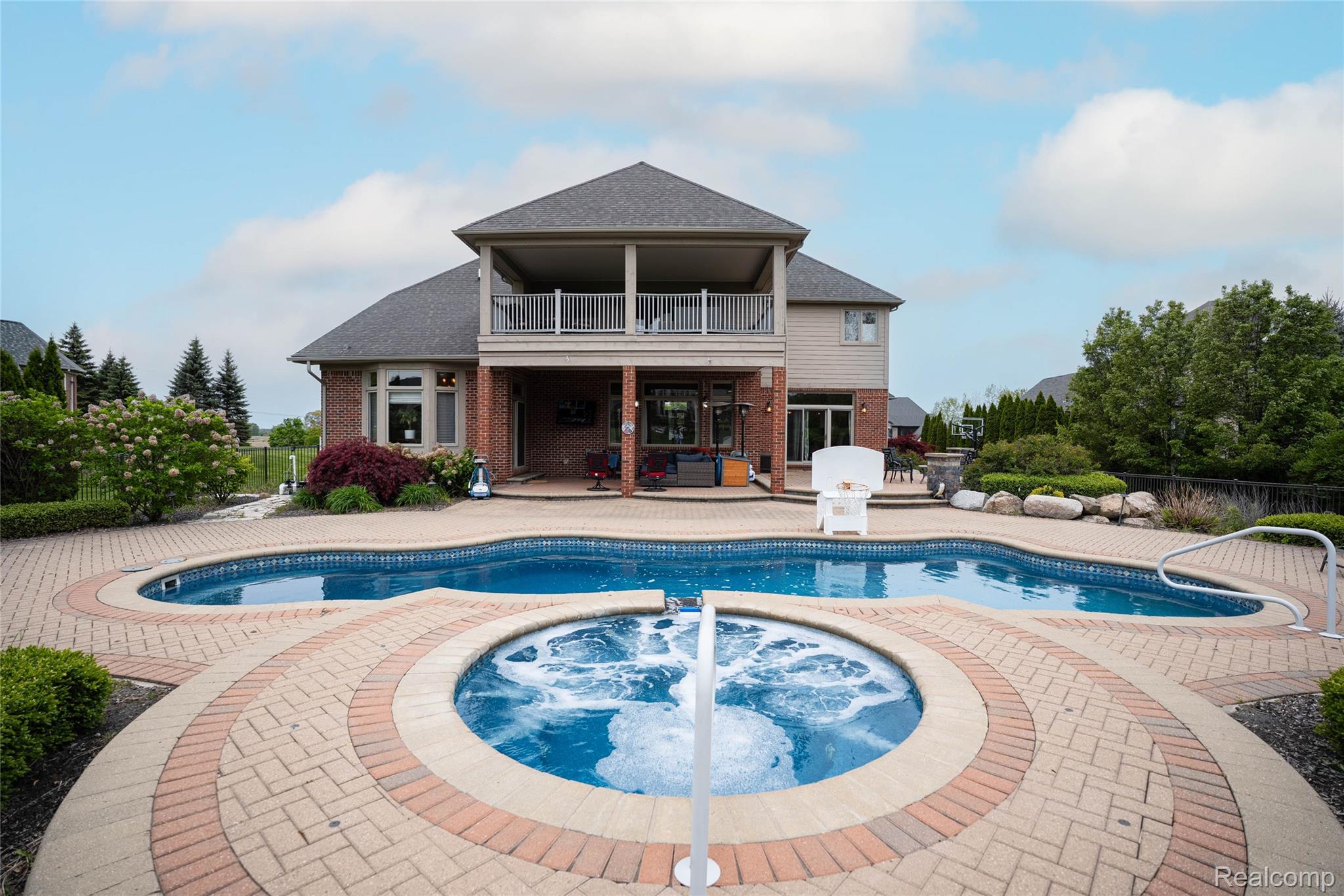 67102 Rachael Lane Washington, MI 48095 - Photo 3 of 37 View of pool featuring an in-ground hot tub, a balcony, and patio surround