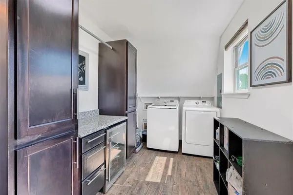 a kitchen with a refrigerator and white cabinets