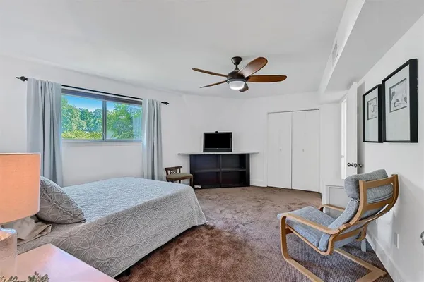 a living room with furniture a window and a flat screen tv
