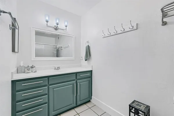 a bathroom with a sink vanity and a mirror