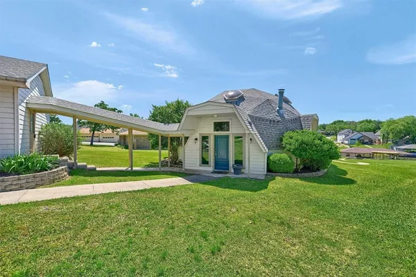 a view of a house with a yard and plants