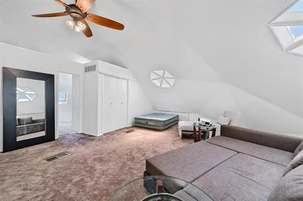 a bedroom with furniture and window