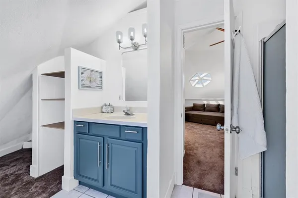 a en suite bathroom with a sink a mirror and shower