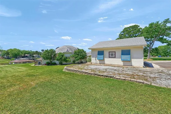 a view of a house with a backyard