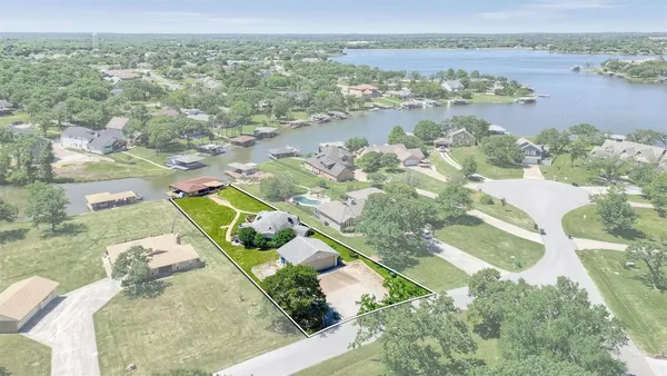an aerial view of a house with a lake view