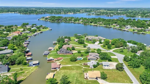an aerial view of lake and residential houses with outdoor space