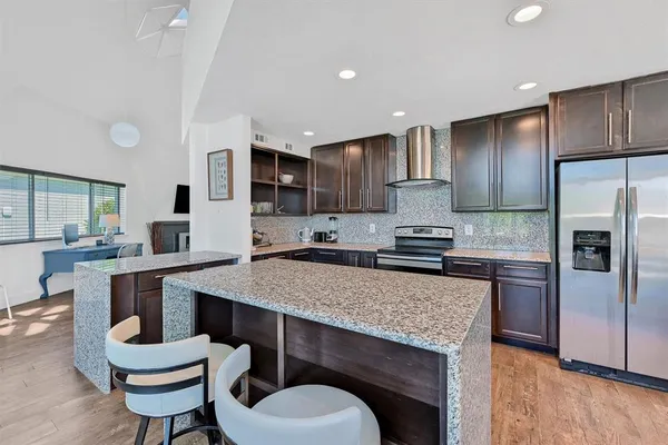 a large kitchen with a table and chairs