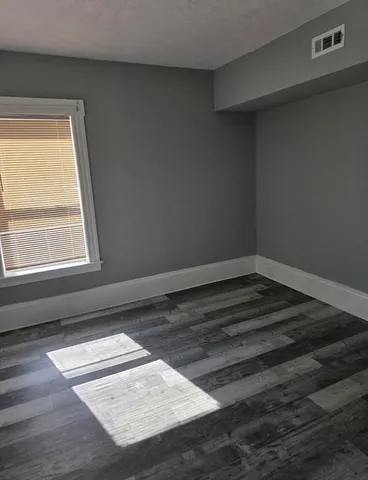 a view of wooden floor in an empty room