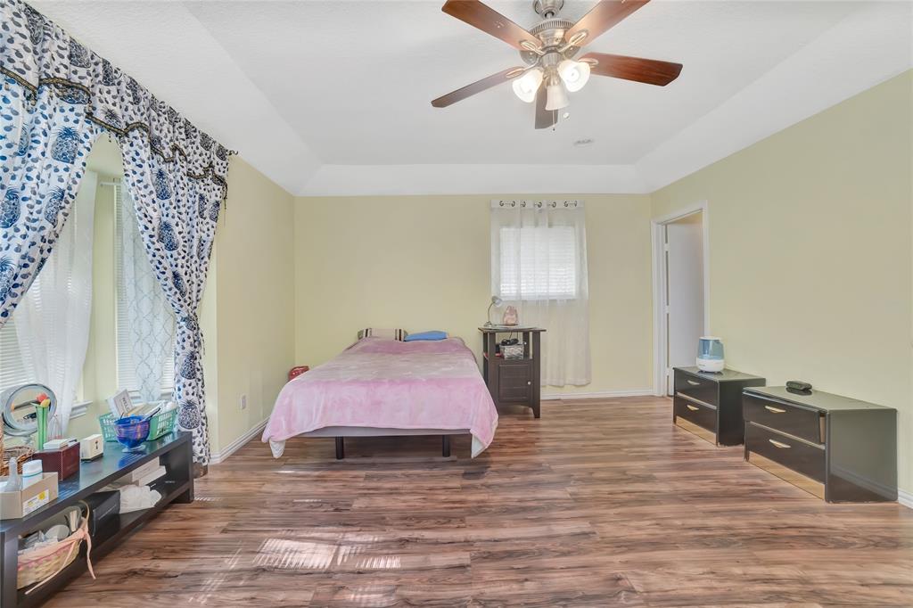 6021 Sycamore Creek Road Edgecliff Village, TX 76134 - Photo 17 of 37 Bedroom with wood finished floors, baseboards, and ceiling fan