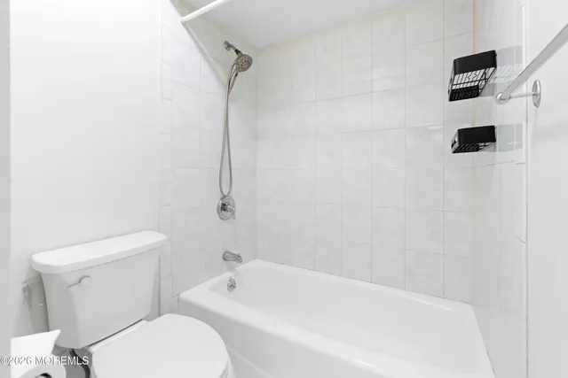 a sign that is on a brick wall with a tree