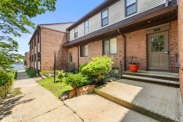 a kitchen with granite countertop a sink a stove and cabinets